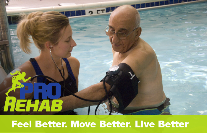Physical Therapist with patient in pool.